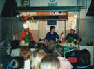 Committee members Kim and Maxine from Kilmood Playgroup display their culinary skills in front of a large and enthusiastic audience at a fundraising evening.